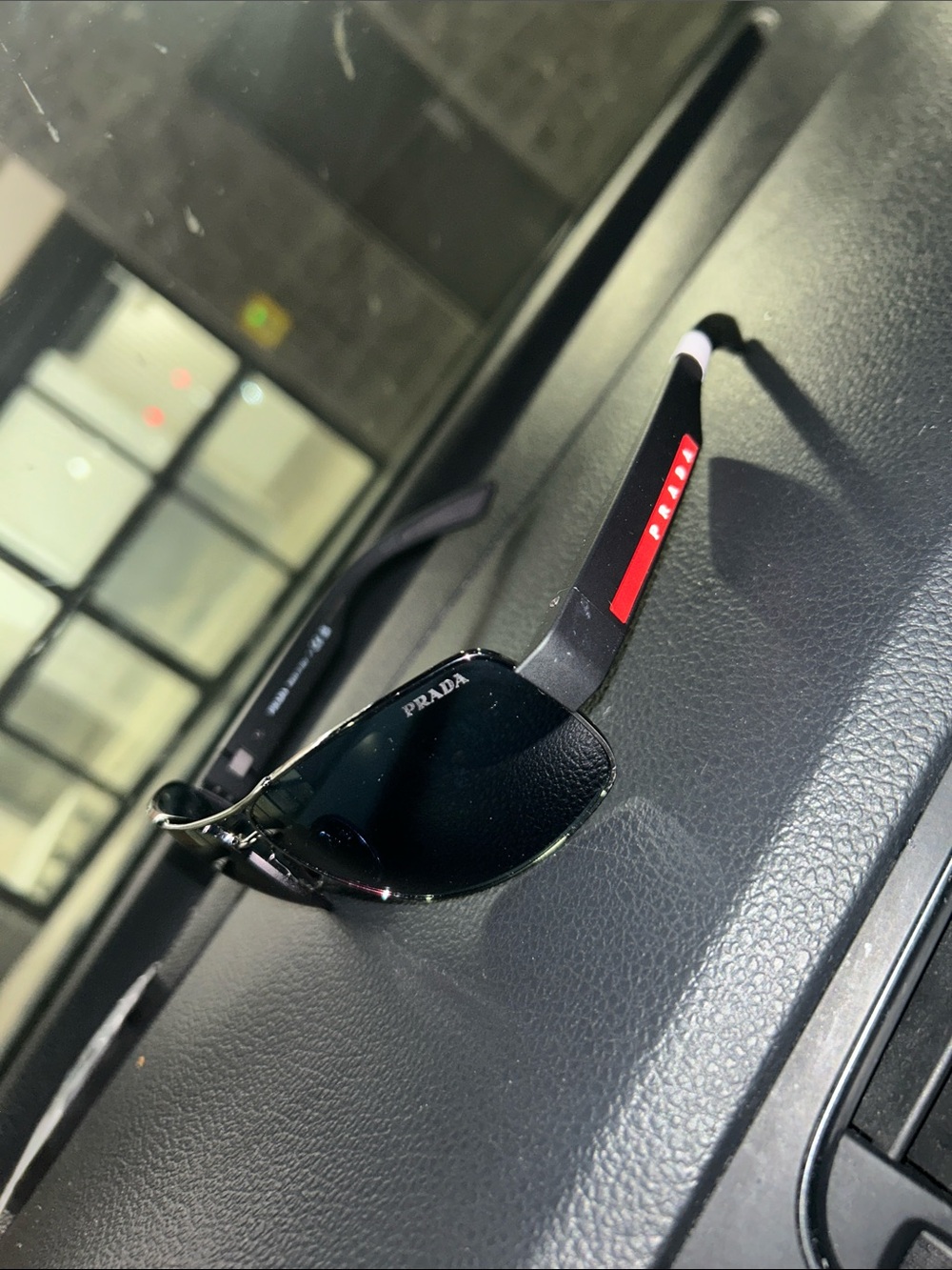 Prada Men’s Black Sunglasses with Red Temple Accents